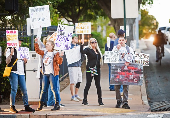 JUSTICE FOR BUBS Demonstrators protesting the SLO Police Department stand at the corner of Santa Rosa and Monterey streets on Jan. 14. They chanted, "SLOPD we want the body cam! SLOPD is not above the law!" - PHOTO BY JAYSON MELLOM