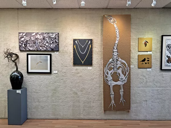 A WIDE ARRAY This wall of the Art Center Morro Bay features a multitude of media. Sculptures, photographs, and cardboard canvases complement one another. - PHOTOS BY MALEA MARTIN