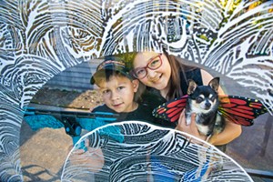 BUTTERFLY VIEWS Avian Mettler, 8; his sister, Cielle Mettler,11; and dog-mascot Layla peer through some of their father’s handiwork. The Mettlers’ Monarch Window Cleaning specializes in getting that glass extra clear—clear enough for our readers to vote them Best Window Cleaning Service. - PHOTO BY JAYSON MELLOM