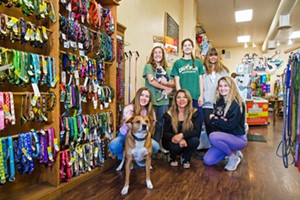 RUFF LIFE Left to right: Madi Erickson, Tails Pet Boutique owner Shelley Stuckey, and Lilli Sanders (front row); Raegan Gage, Rhona Haworth, and Chloe Stuckey (back row); and dogs Stella, Sush, and Shefoo hang out at the Best Place to Pamper Your Pet. - PHOTO BY JAYSON MELLOM
