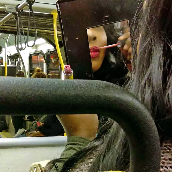 LABIOS Poet and photographer Marisela Norte's images capture the fashion and colors of the Latino community, such as a woman applying lip gloss while in transit. - PHOTOS COURTESY OF STUDIOS ON THE PARK