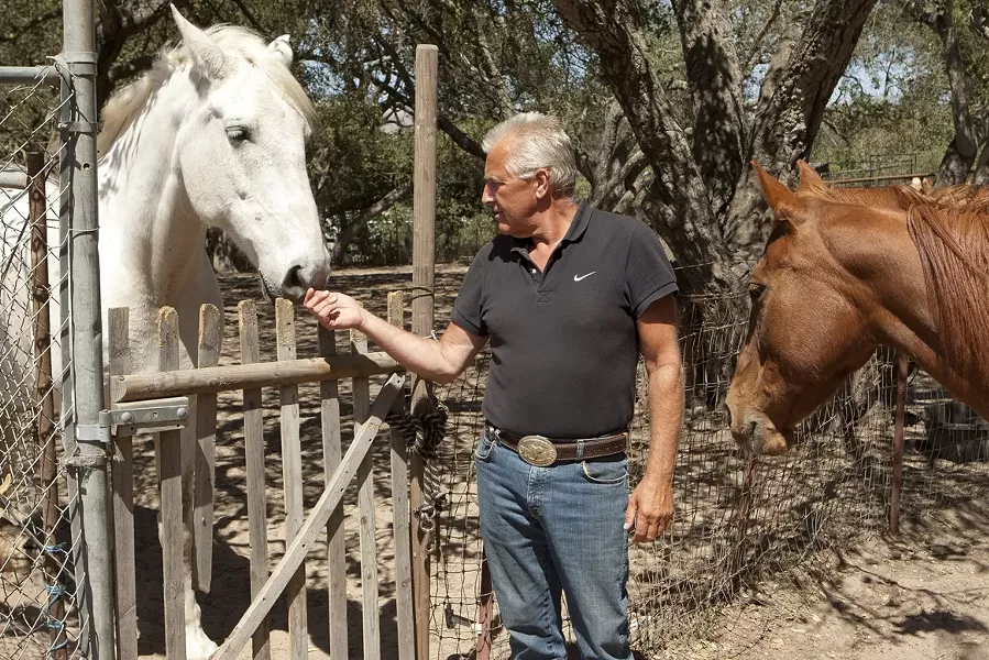 HORSE HEALING : Angel (left), Hans van Randwijk, and Pita (right) are lending a helping hand—and hoof—to people in need. - PHOTO BY STEVE E. MILLER