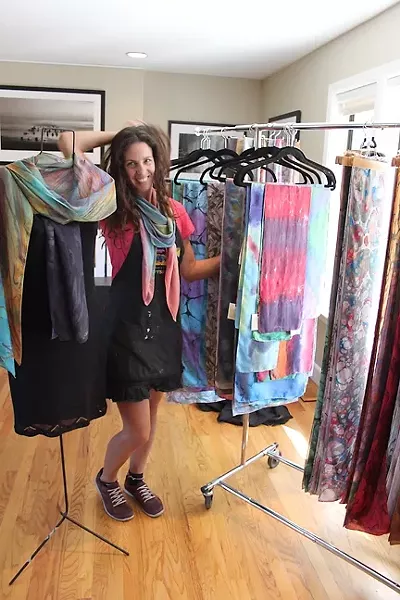 COLOR ME HAPPY : ColorVibe Design’s Sharon Gellerman blends in with her silk scarves on display. - PHOTO BY REBECCA LUCAS