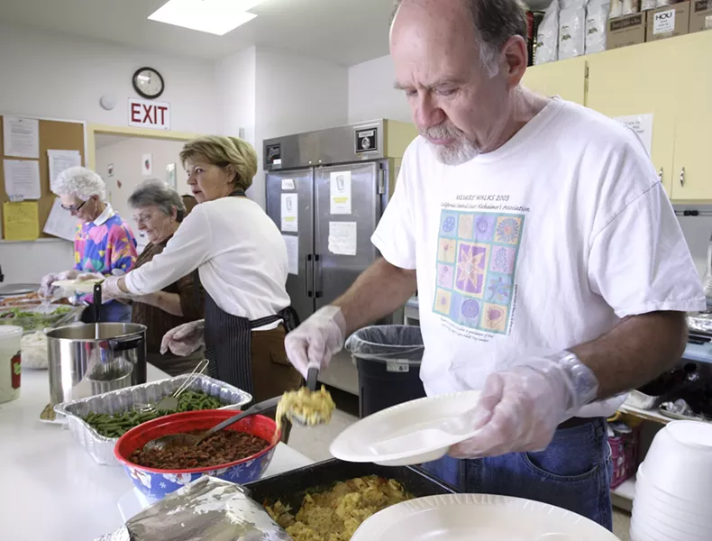 GOOD AND PLENTY : From right to left, volunteers Mike Draze , Dianne Draze (married to Mike), Dorothy McCoie and Beth Peterson serve clients at the Prado Day Center. - PHOTO BY STEVE E. MILLER