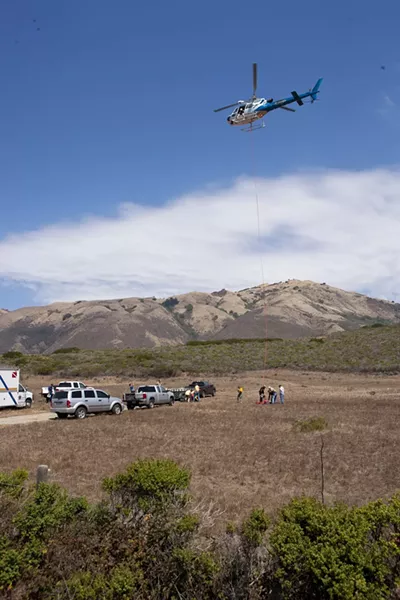 HIGH FLYING WEED: A California Highway Patrol helicopter dropped off bundles of marijuana found at a remote beach near Piedras Blancas for Sheriff’s Department trucks to haul them off to the sheriff’s headquarters. - STEVE E. MILLER