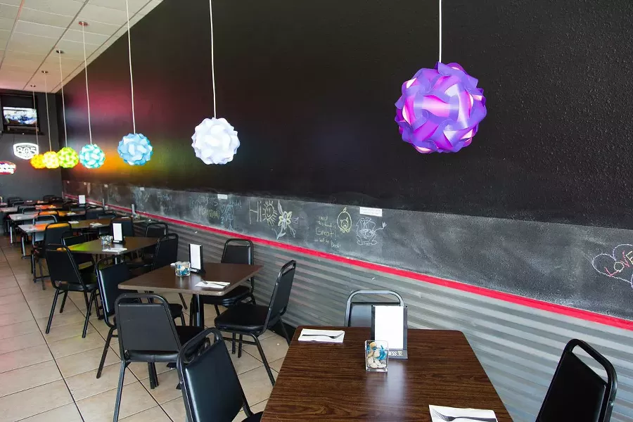 A GREAT PLACE TO PARK: The new restaurant, complete with truck tire installed in bar and joyful colored lights, reflect Nunes’ energetic personality and vibrant Asian fusion creations. - PHOTO BY TOM FALCONER