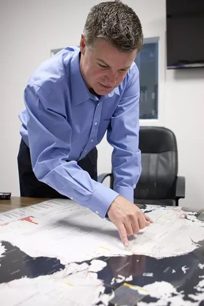 IN OUR OWN BACKYARD : Tim Williams, president of San Luis Obispo-based telecommunications firm Digital West, showed off a map of trans-Pacific fiber-optic cables on the West Coast—a cluster of which runs from Asia straight to the shores of Grover Beach. - PHOTO BY STEVE E. MILLER