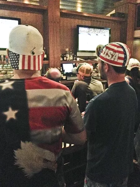 BROS-R-US: Even in the dark bar, it was hard to miss the omnipresent Stars and Stripes attire. - PHOTO BY RHYS HEYDEN