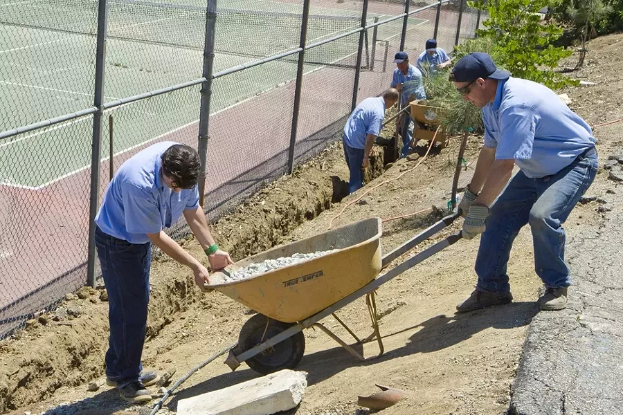 MEN AT WORK : Inmates at the SLO County Jail’s Honor Farm spent a day out in Santa Margarita on May 13, installing a drainage system for the Community Center as part of a pilot program to start an afterschool program for local kids. - PHOTO BY STEVE E. MILLER