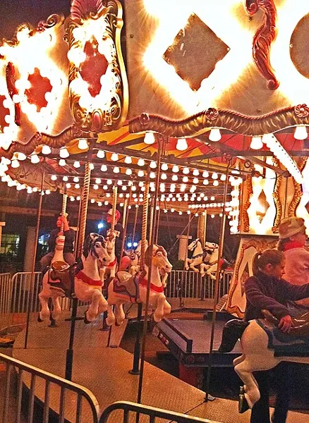 AROUND WE GO: Like Santa’s House, an old fashioned carousel is a big Christmastime tradition in the SLO Mission Plaza. - FILE PHOTO BY GLEN STARKEY