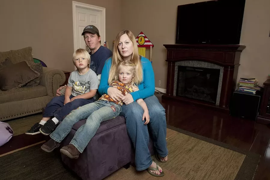 GETTING BY : Molly O’Leary and Ryan Risley are getting by now, but they don’t know how they’ll afford to stay at home with their kids if a $250-per-month sewer bill forces them both to work full time. - PHOTO BY STEVE E. MILLER