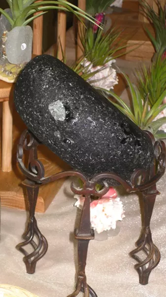 MAGIC ROCK: This chunk of industrial glass from a factory in London glows under black lighting. It’s called “Vaseline glass,” which means it’s old and chock full of uranium. Fun! - PHOTOS BY NICK POWELL