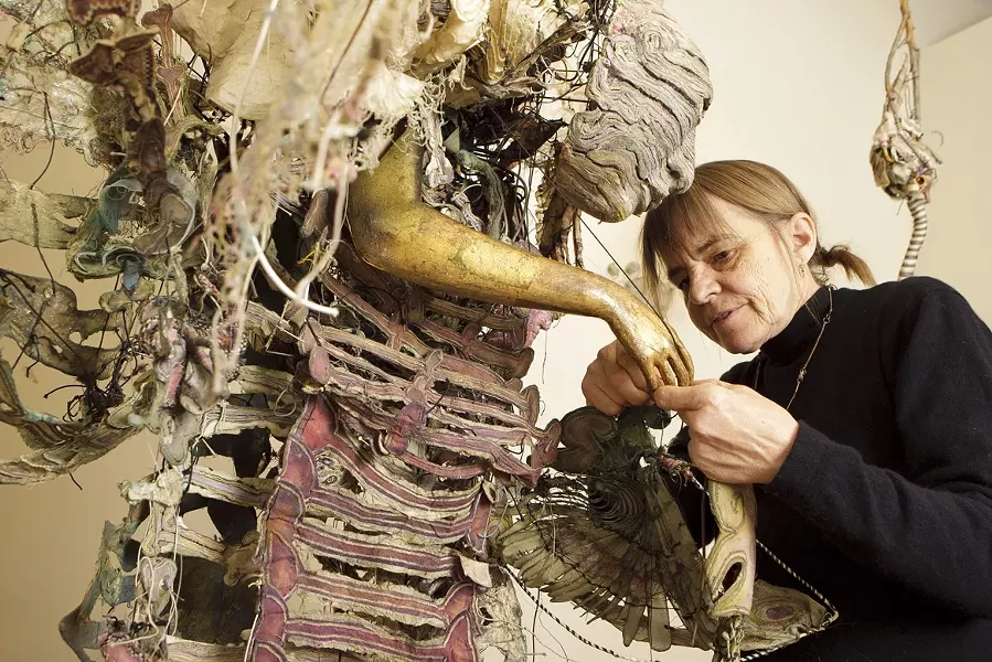 FINAL TOUCHES : Pictured is Higby hard at work before the opening of her exhibit “Noh Works.” Her sculptural costumes, made of wood, silk, gold leaf, ceramic, lacquer, fabric, and paper, can take years to complete. - PHOTOS BY STEVE E. MILLER