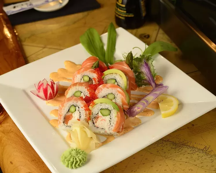 DELICIOUS SEA TREATS : A sampling of different plates from Off the Hook Sushi Bar and Grill includes the Alaskan king roll (salmon, asparagus, crab, and avocado), Morro Bay red snapper and chips, and oven-roasted Morro Bay red snapper with a seafood mussel risotto. - PHOTO BY STEVE E. MILLER