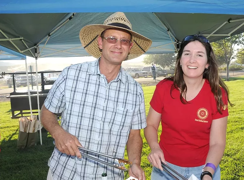 TONGS IN HAND : Bill Sheffer of Halter Ranch Vineyard and Robin Zazueta of Vina Robles dish up some tasty fare, to raise money for the Rotary Club’s scholarship fund. - PHOTO COURTESY OF PASO ROBLES ROTARY