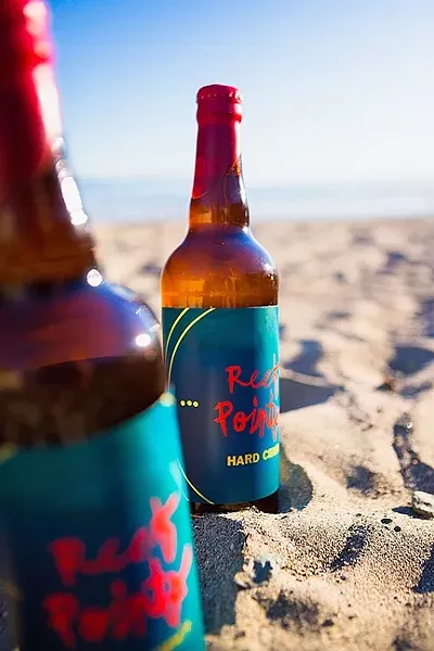 APPLE OF YOUR MOUTH: Made in Cayucos by local boys, it made perfect sense that these frosty bottles of Reef Points Kid Neptune hard cider would be enjoyed at the inspiration’s source. - PHOTO BY KAORI FUNAHASHI