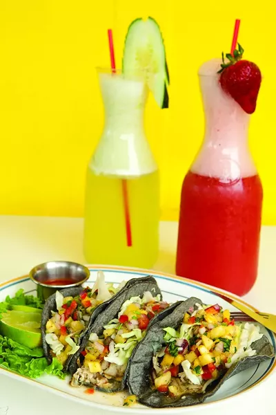 TACOS DE PESCADO: Fish tacos made with fresh tilapia are complemented well by either cucumber or strawberry Agua Fresca. - PHOTO BY STEVE E. MILLER