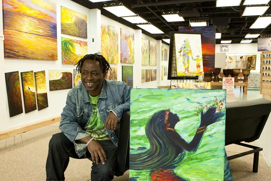 DANCING WITH COLOR : Abbey Onikoyi recently moved his art space, Spirits of Africa Gallery, to the more visible 672 Higuera St. in downtown San Luis Obispo. Born and raised in Nigeria, Onikoyi has called the Central Coast home since 2002. - PHOTO BY STEVE E. MILLER