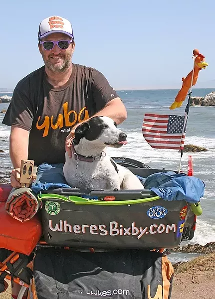 PEDALING FOR PAWS: Mike Minnick and his shelter dog Bixby were regulars around SLO until late May. The pair has spread their message of rescue dog adoption and is now moving onward across the country. - PHOTO BY HAYLEY THOMAS