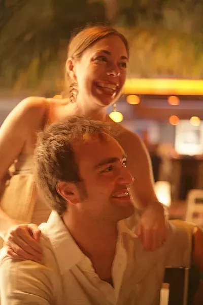 LOVE GLOW : Rubey and Gabe share a laugh with friends at their rehearsal dinner in Playa del Carmen, Mexico. - PHOTO BY GLEN STARKEY