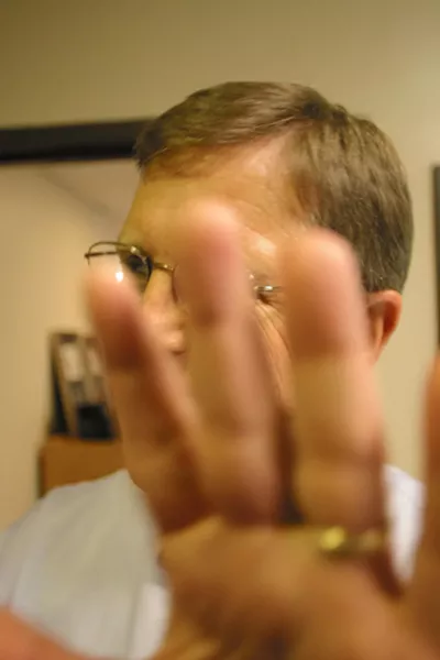 NO PHOTOS : District Attorney Gerald Shea fends off a New Times photographer prior to a 2003 interview. - FILE PHOTO BY CHRISTOPHER GARDNER