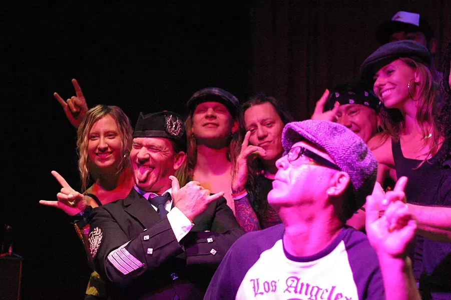 HELL AIN’T A BAD PLACE TO BE! : (Left to right) Concertgoer Joanne Halvorson, bagpiper Paul Dunn, lead guitarist Josh Blodgett, lead singer Kelly Atwell, contest winner and birthday boy Damon Haydu, bassist Andy Shellcross, and New Times graphic designer Dora Mountain take to the stage after the show. - PHOTOS BY GLEN STARKEY