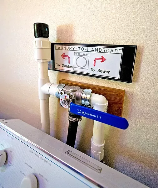 CHANGING TIDE: A simple lever allows water to flow from the washing machine to the sewer or to the garden. - PHOTO BY KAORI FUNAHASHI