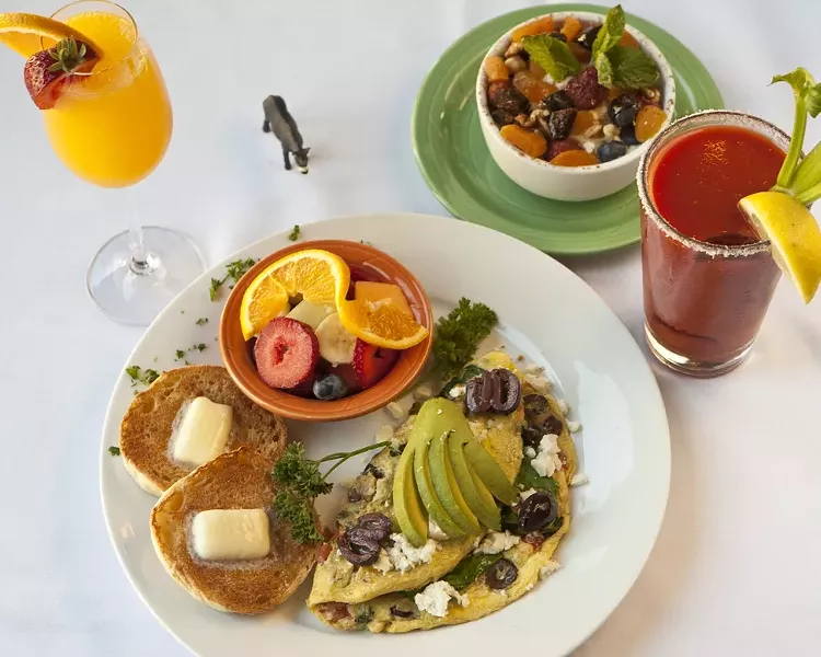 GRECIAN DELIGHTS : The Wild Donkey café is now serving Greek inspired breakfasts like this Greek omelet and Greek Island fruit and yogurt dish. Also pictured are a Bloody Mary and Mimosa. As the server Lane put it, “I never have one drink with breakfast!” - PHOTO BY STEVE E. MILLER