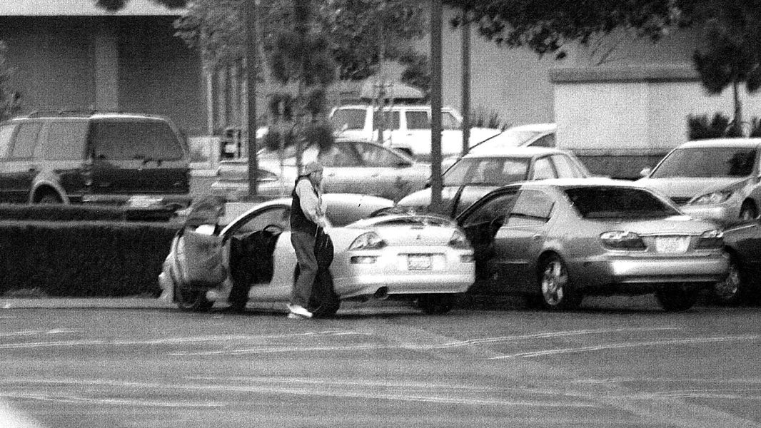 HAND OFF : Court documents contain photographs that show confidential informant Daniel Victor Lee carrying a bag of marijuana back to a car, where undercover agent “Rick” was waiting. - PHOTO FROM COURT DOCUMENTS