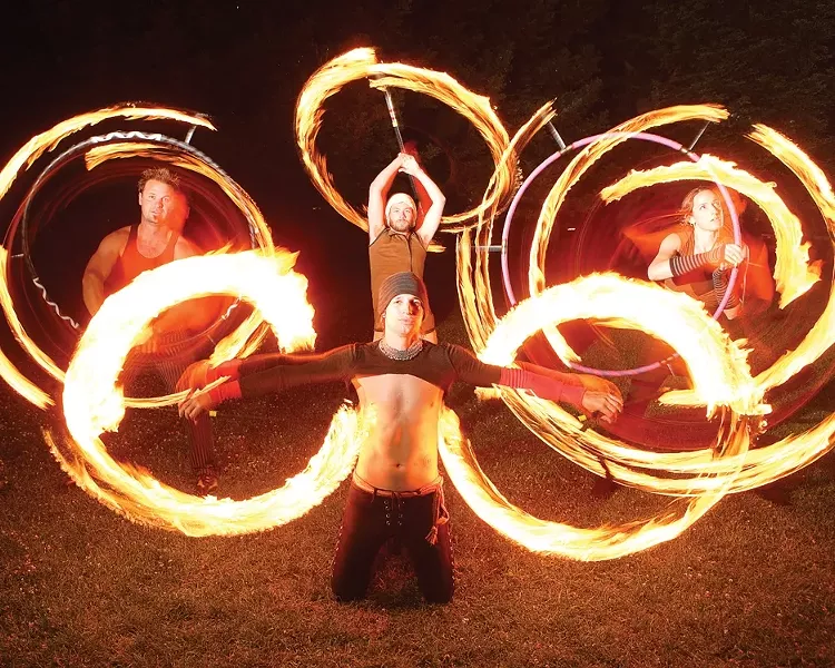 SLO HEAT: Fluid Luminescence members Chris Williams (front), Grant Leonard, Josh Parker, and Laurie Hobbs (l-r) put on an impromptu fire show at the park. - PHOTO BY STEVE E. MILLER