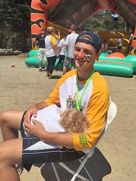 COMPASSIONATE, DRIVEN, GIVING: Nick Attala, a senior at San Luis Obispo High School, spends a summer day as a counselor at Jack’s Helping Hand’s annual summer camp for children with cancer. Nick and his cousin, Sarah Attala, received Presidential Volunteer Service Awards on Dec. 15 for volunteering more than 100 hours to nonprofits in the past year. - PHOTO COURTESY OF KAREN BORGES