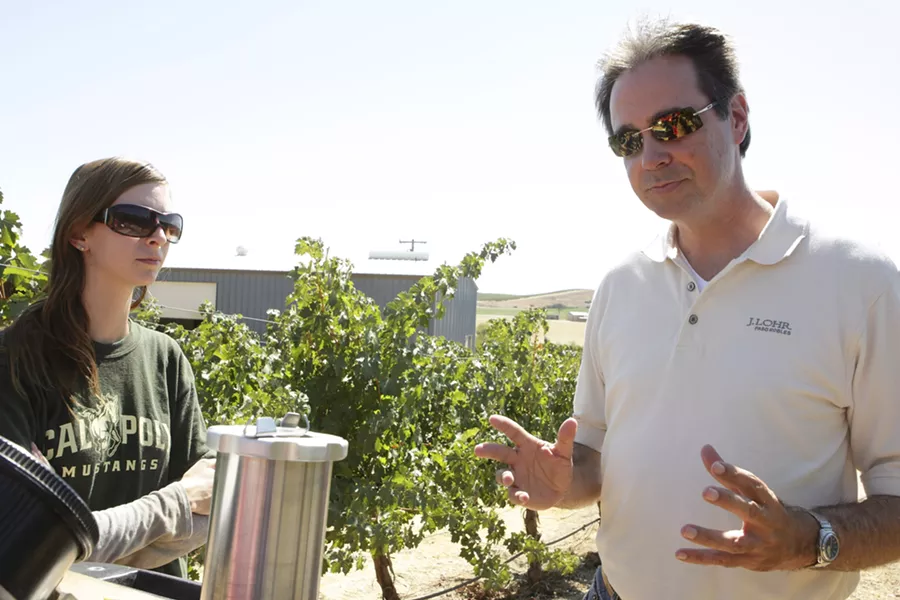 WATER CONSERVATION IN ACTION : Steve Lohr (right) of J. Lohr Vineyards & Wines shows Cal Poly intern Katherine Malin (left) how to use “pressure bombing” to determine irrigation schedules. - PHOTO BY STEVE E. MILLER