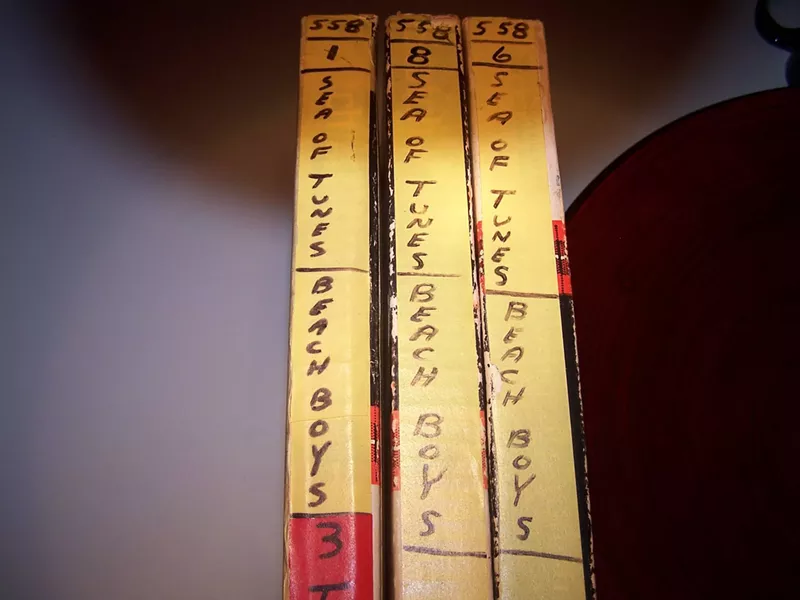 BURIED TREASURE : These reel-to-reel tapes from a 1964 Beach Boys recording session—in the possession of Atascadero resident Lance Robison since he was 13 year old—were sold to Capitol Records last year, the proceeds used to finance Robison’s own album, Codependance Beach. - PHOTO COURTESY OF LANCE ROBISON