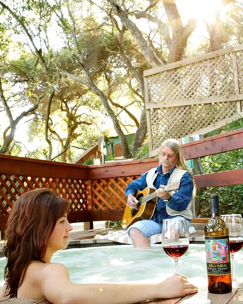 INDULGE : Relax in a Sycamore Springs tub like Casey Moss. David Talmage will sing only in the lounge during the Central Coast Folk Festival. - PHOTO BY STEVE E. MILLER