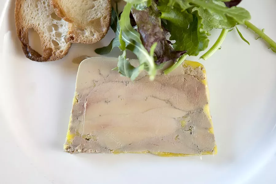 PLATED: : A slice from a terrine of foie gras is strong enough to be served on its own, accompanied - by greens and a toasted baguette round. - PHOTO BY STEVE E. MILLER