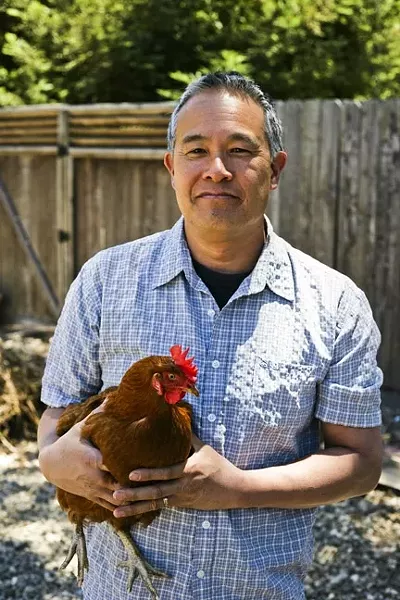 CHICKEN LOVER: Jeff Bague thinks of his chickens as pets, and if one stops laying, he’d keep it around. - PHOTO BY GLEN STARKEY