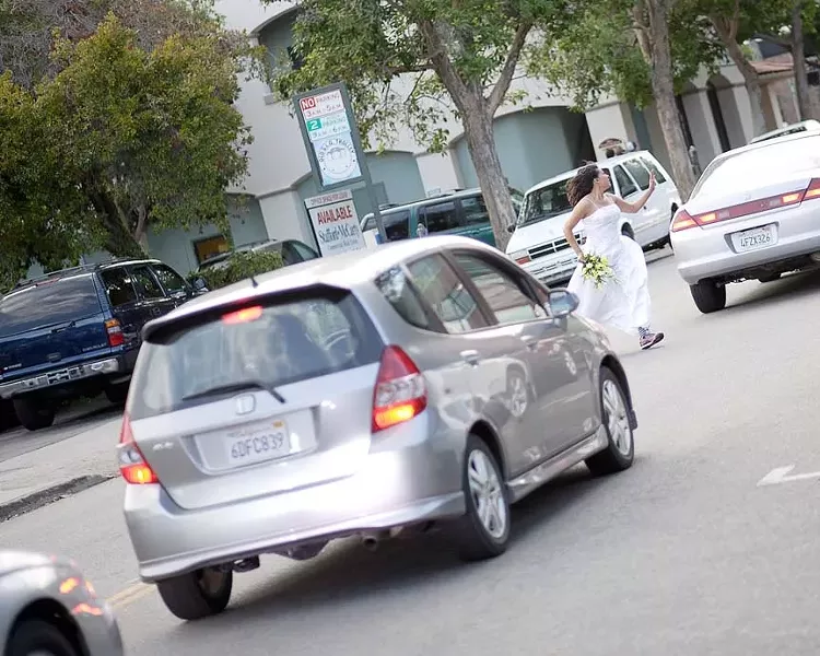 RUNAWAY WEDDING PARTY : Our bride, Sally (Tanya Gallardo) dashes to freedom, through a busy Farmer’s Market. - PHOTO BY STEVE E. MILLER