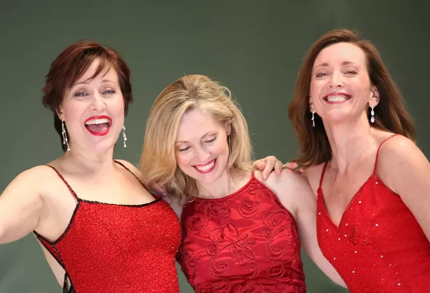 RED AS SANTA: Karen Culliver, Mary D’Arcy, and Teri Bibb put on a show that embodies the holly, jolly spirit of the season. - PHOTO COURTESY OF THE PHANTOM’S LEADING LADIES