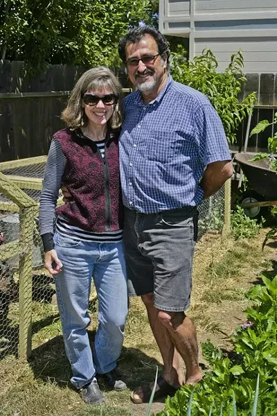 DREAMERS: Liz Rhoads Cordoba and George Griffin enjoy the fruits of their labor in their extensive backyard garden. - PHOTO BY GLEN STARKEY