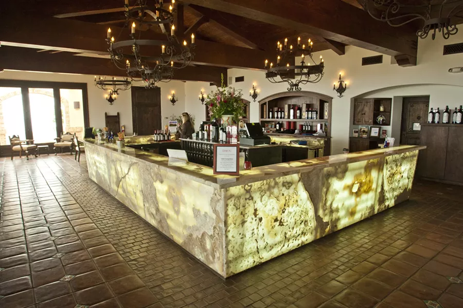 GLOWING STONE : The Daou Vineyards tasting room has a backlit stone bar with room for at least 40 people to try different wines. - PHOTO BY STEVE E. MILLER