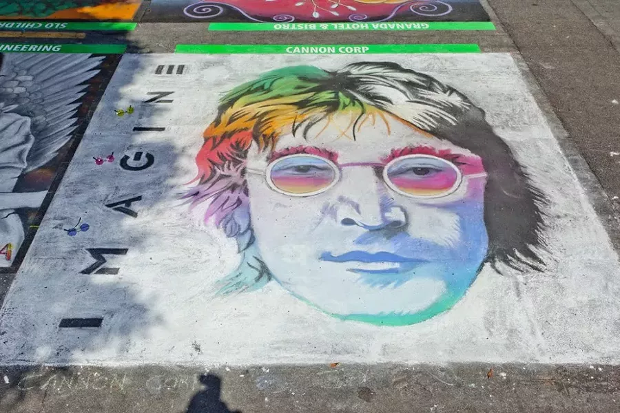 DOUBLE FANTASY: The street painting festival attracts varied and vibrant works of art like last year’s entry from Cannon Corp., a stunning, rainbow John Lennon. - PHOTO BY JOSEF KASPEROVICH