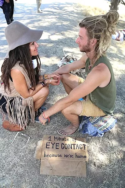 HUMAN CONTACT: Phillip Debies and Kiyana Broom just met, but that doesn’t stop them from instantly sharing more eye contact than most people have throughout an entire day. “I’ve met so many amazing people, even if we never see each other again and I don’t even know your name ... it’s that connection that happens from just looking in people’s eyes,” Debies said. Broom continued, “It’s so primal and I think it’s uncomfortable sometimes in our regular society to look at someone for a long period of time … I think this is just a really honest, open, pure way to look at it.” - PHOTO BY DYLAN HONEA-BAUMANN