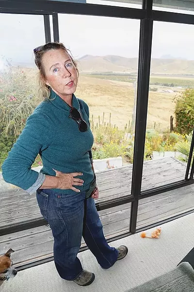 SICK TO HER STOMACH : Morro Bay resident Jacqueline Marie overlooks the Righetti Ranch from her bedroom window. She lives on Nutmeg Avenue, and that view could change if the city builds a wastewater treatment facility on the ranch. - PHOTO BY DYLAN HONEA-BAUMANN