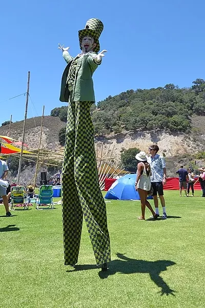 DOWN THE RABBIT HOLE: The Mad Hatter moves through the crowd on stilts during the Central Coast Oyster and Music Fest on July 9. - PHOTO BY GLEN STARKEY