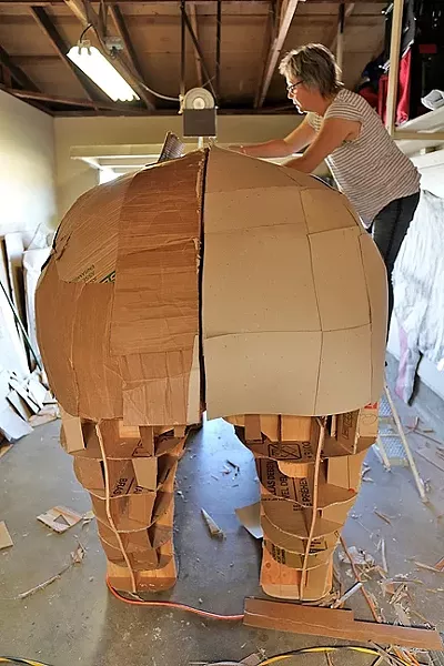 BIG, BEAUTIFUL RHINOCEROS : Abby Belknap, an artist in the Central Coast Sculptors Group, works on the sizeable rear end of the rhinoceros. - PHOTO BY DYLAN HONEA-BAUMANN