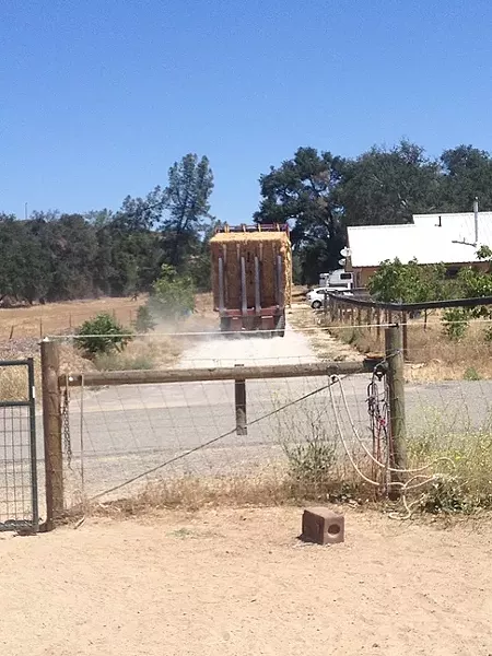HAY NOW: A truck passes on an access road that cuts through the property of Eric Michielssen, organic farmer and candidate for the 5th District county supervisor seat. Michielssen is being sued by his neighbor, John Philbrick, after a dispute over Philbrick’s use of the road for his farming operations grew contentious. Michielssen said it’s politically motivated. - PHOTO COURTESY OF ERIC MICHIELSSEN
