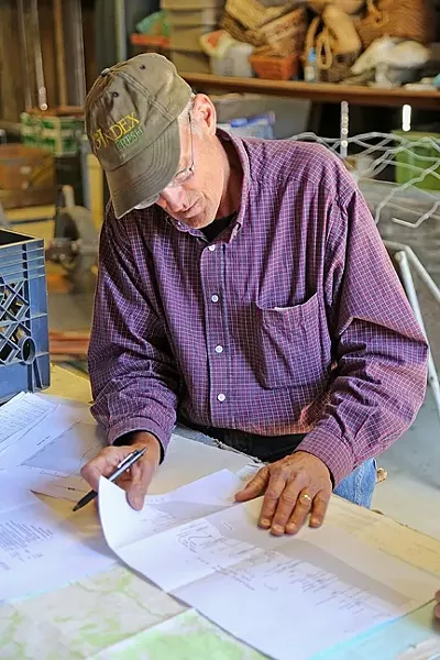 GEOLOGY: George Kendall uses maps and graphs to explain the hydrogeology beneath his property and why a percolation basin benefits the shallow aquifer. - PHOTO BY DYLAN HONEA-BAUMANN