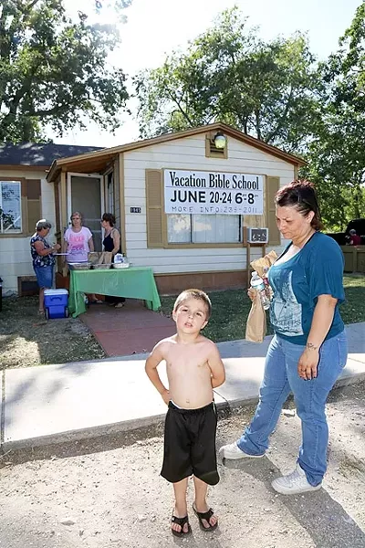 NUTRITION: A mother, Cheryl, and her 4-year-old son, Zaden, pick up dinner at the People’s Kitchen in Paso Robles before walking across the street to Pioneer Park. - PHOTOS BY DYLAN HONEA-BAUMANN