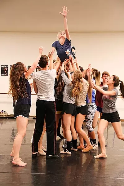 IF YOU LOSE, THE DEVIL GETS YOUR SOUL: A group of dancers lifts up a young Betty Parris (Madison Price), whose soul is being tortured by the devil, during a rehearsal for the Civic Ballet’s production of The Crucible. - PHOTO BY DYLAN HONEA-BAUMANN