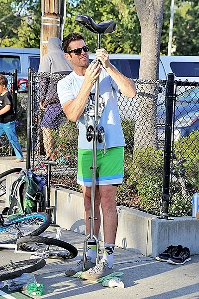 7-FOOT TALL: Mark Wilder sets up a tall unicycle during a practice session at Meadow Park. - PHOTO BY DYLAN HONEA-BAUMANN